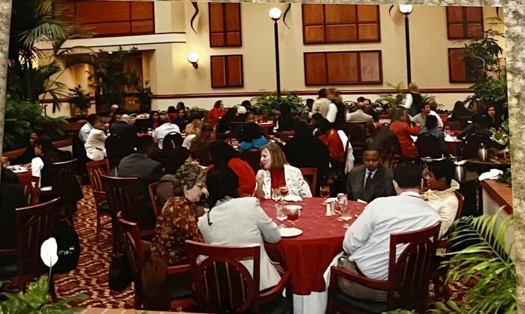 A group of people sitting at tables in a restaurant.