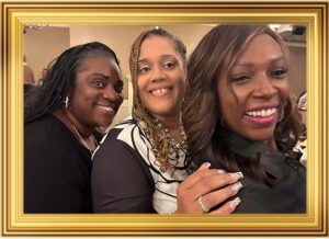 Three women posing for a picture in front of a mirror.